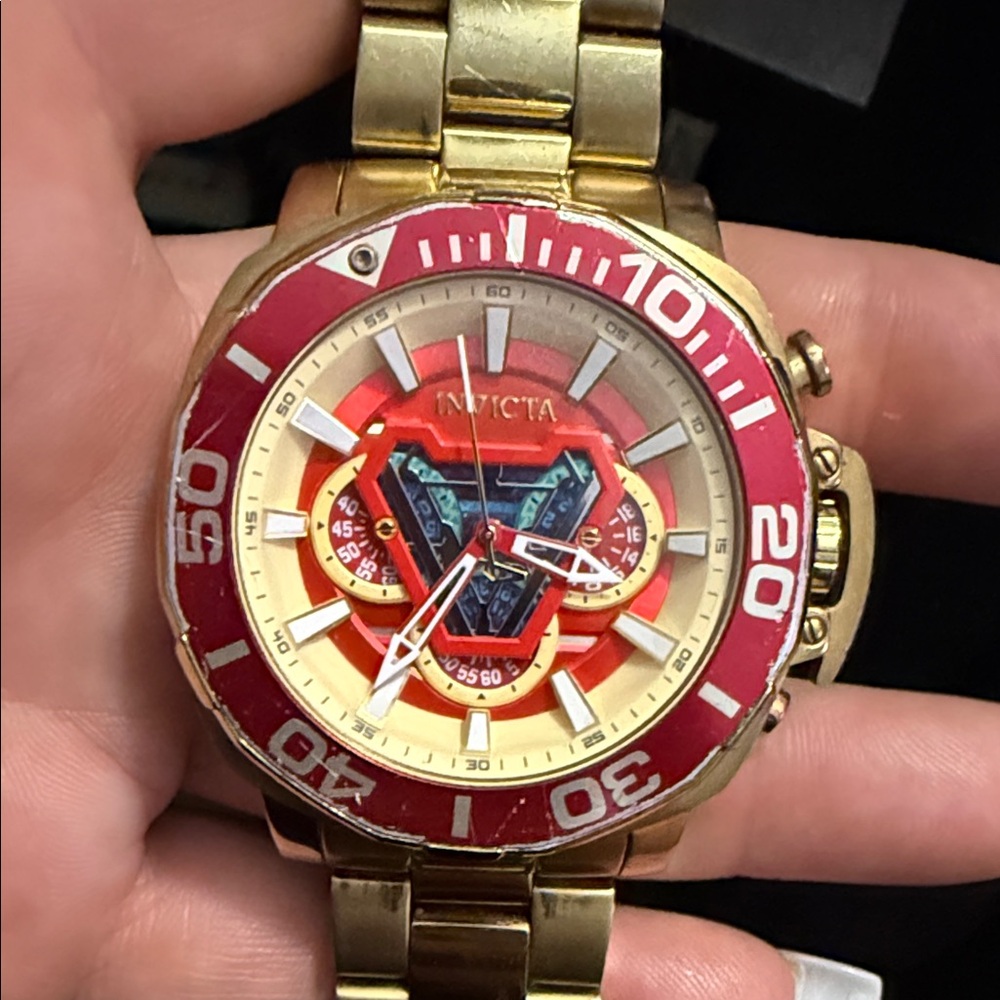 Invicta Gold Tone Watch with Red Bezel and Dial Accents